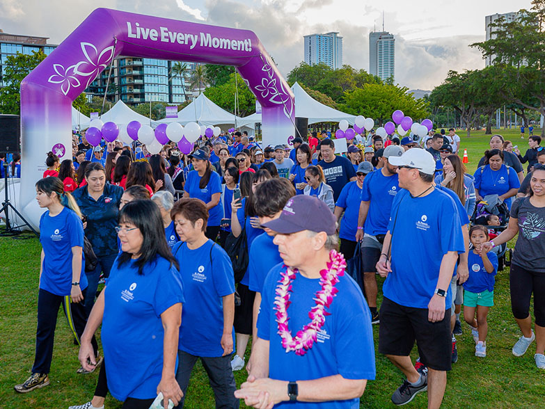 Group of walkers with freestanding inflatable arch in background